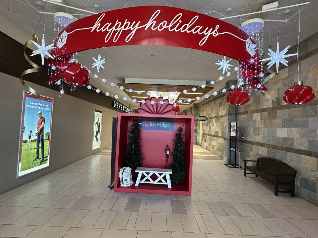 Custom holiday ornaments, stars and a Happy Holidays arch inside Red Cliffs Mall