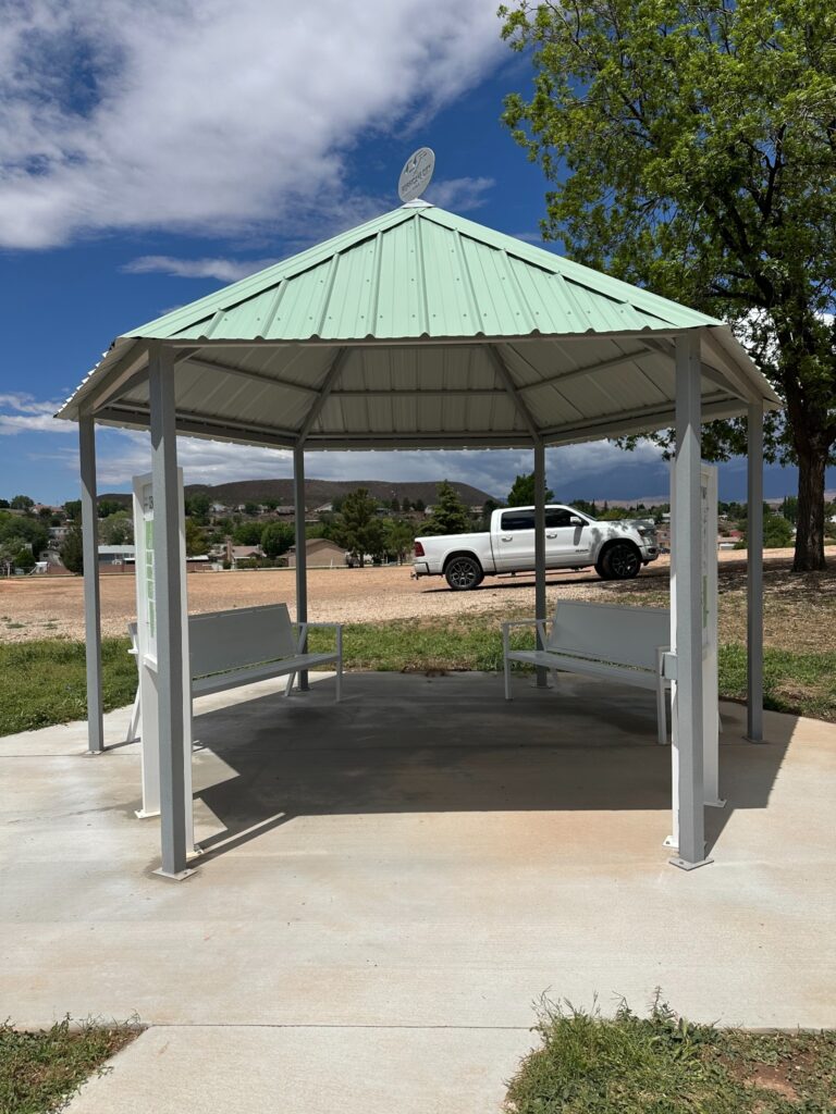 Completed metal gazebo at Hurricane City Cemetery with two benches and map panels