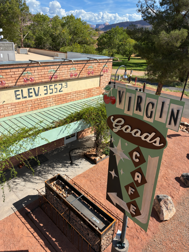 Virgin Goods Cafe dimensional sign beside the cafe building and landscaped grounds